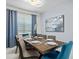 Dining room with wooden table, seating for six, modern chandelier, and blue accents at 9001 Flamingo Key Way, Kissimmee, FL 34747