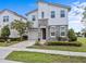 Charming two-story home features a stone facade, manicured lawn, paver driveway, and attached garage at 9001 Flamingo Key Way, Kissimmee, FL 34747