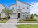 Charming two-story home features a stone facade, manicured lawn, paver driveway, and attached garage at 9001 Flamingo Key Way, Kissimmee, FL 34747