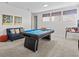 The game room features a blue pool table, comfortable seating and ample lighting at 9001 Flamingo Key Way, Kissimmee, FL 34747