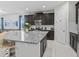 Spacious kitchen features dark cabinets, granite countertops, stainless appliances, and a breakfast bar at 9001 Flamingo Key Way, Kissimmee, FL 34747