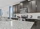 Bright kitchen with dark wood cabinets, stainless steel appliances, granite counters, and a breakfast bar at 9001 Flamingo Key Way, Kissimmee, FL 34747