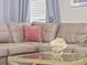 Cozy sectional sofa with decorative pillows and a glass coffee table featuring a floral centerpiece at 9001 Flamingo Key Way, Kissimmee, FL 34747