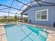 The large screened in swimming pool has an attached spa and is perfect for relaxing at 9001 Flamingo Key Way, Kissimmee, FL 34747