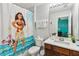 Charming bathroom with Moana-themed shower curtain and a dark wood vanity at 2710 Manesty Ln, Kissimmee, FL 34747