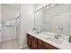 Bathroom features double sinks, a large mirror with vanity lights, and tiled floors at 2710 Manesty Ln, Kissimmee, FL 34747