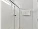 Bathroom with tiled shower stall, glass doors, shower head and two clean white towels at 2710 Manesty Ln, Kissimmee, FL 34747