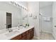 Bathroom with a double sink vanity, large mirror and a shower stall at 2710 Manesty Ln, Kissimmee, FL 34747