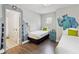 Charming bedroom with creative Monsters, Inc. themed art, and ensuite bath at 2710 Manesty Ln, Kissimmee, FL 34747