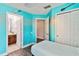 Whimsical bedroom with turquoise walls, themed decor, and ensuite bath and closet access at 2710 Manesty Ln, Kissimmee, FL 34747