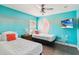The Moana-themed bedroom boasts two twin beds, a ceiling fan, and a mounted TV at 2710 Manesty Ln, Kissimmee, FL 34747