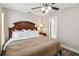 Comfortable bedroom featuring a wood headboard, bedside table, and wood-look flooring at 2710 Manesty Ln, Kissimmee, FL 34747