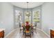 Bright breakfast nook featuring a round table, decorative chairs, and large windows at 2710 Manesty Ln, Kissimmee, FL 34747