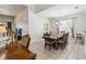 Bright dining room featuring a large wooden table with seating for eight and a modern chandelier at 2710 Manesty Ln, Kissimmee, FL 34747