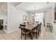 Formal dining room with a large table set for a meal and a bright chandelier at 2710 Manesty Ln, Kissimmee, FL 34747