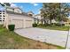 Charming two-story home with a two-car garage, lush landscaping, and a well-maintained lawn at 2710 Manesty Ln, Kissimmee, FL 34747
