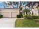 Charming two-story home with a two-car garage and lush, well-maintained landscaping at 2710 Manesty Ln, Kissimmee, FL 34747