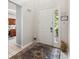 Entryway view featuring a white front door, a patterned rug and glimpses of kitchen at 2710 Manesty Ln, Kissimmee, FL 34747