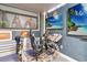 Gaming room with custom chairs, gaming setups, and views of a beach scene on the screen at 2710 Manesty Ln, Kissimmee, FL 34747