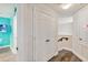 Bright hallway features wood-look floors and white doors leading to rooms and stairs at 2710 Manesty Ln, Kissimmee, FL 34747