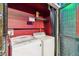 Laundry area with a stackable washer and dryer unit, and metal shelving at 2710 Manesty Ln, Kissimmee, FL 34747