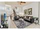 Open-concept living room with tile flooring, a staircase, and comfortable seating at 2710 Manesty Ln, Kissimmee, FL 34747