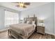 Calming main bedroom with a queen-size bed, neutral tones, and sheer curtains at 2710 Manesty Ln, Kissimmee, FL 34747