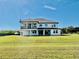 Spacious backyard with a covered patio and balcony, perfect for outdoor entertaining and relaxation at 7443 Lake Albert Dr, Windermere, FL 34786