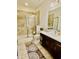 Tidy bathroom featuring walk-in shower, single sink vanity with white countertop, and ceramic tile flooring at 7443 Lake Albert Dr, Windermere, FL 34786