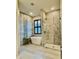 Luxurious bathroom with a soaking tub, modern shower, and decorative tiled walls at 7443 Lake Albert Dr, Windermere, FL 34786