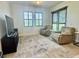 Cozy bedroom featuring two reclining chairs and a television at 7443 Lake Albert Dr, Windermere, FL 34786