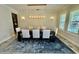 Elegant dining room with a modern chandelier and plantation shutters at 7443 Lake Albert Dr, Windermere, FL 34786