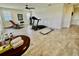 Bright exercise room with hardwood floors and workout equipment, including a treadmill and weight bench at 7443 Lake Albert Dr, Windermere, FL 34786