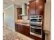 Chef's kitchen with dark wood cabinetry and stainless steel appliances at 7443 Lake Albert Dr, Windermere, FL 34786