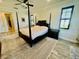 Bright main bedroom with four-poster bed, ceiling fan, and large windows at 7443 Lake Albert Dr, Windermere, FL 34786