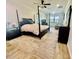 Spacious main bedroom with a four-poster bed, ceiling fan, and a stylish area rug at 7443 Lake Albert Dr, Windermere, FL 34786