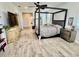 Spacious main bedroom featuring a four poster bed frame, light hardwood flooring, and a ceiling fan at 7443 Lake Albert Dr, Windermere, FL 34786