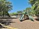 Community playground with modern equipment surrounded by mature trees for shade and enjoyment at 7443 Lake Albert Dr, Windermere, FL 34786