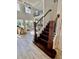 Elegant staircase leading to the upper level with dark wood and wrought iron railings at 7443 Lake Albert Dr, Windermere, FL 34786
