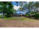 Scenic view of a private backyard with a screened-in pool and mature landscaping, providing a tranquil retreat at 17358 Hwy 27, Clermont, FL 34715