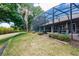 Secluded backyard oasis features a screened-in lanai with lush landscaping and a relaxing atmosphere at 17358 Hwy 27, Clermont, FL 34715