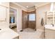 Bright bathroom boasts double sinks, a stylish glass shower, and a view to the main bedroom at 17358 Hwy 27, Clermont, FL 34715