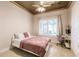 Cozy bedroom features a decorative ceiling, a large window, and a comfortable bed at 17358 Hwy 27, Clermont, FL 34715