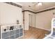 This bedroom offers an expansive mirrored closet and stylish storage solution, complemented by wood flooring at 17358 Hwy 27, Clermont, FL 34715