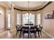 Formal dining room with a dark wood table and seating for six under a decorative chandelier at 17358 Hwy 27, Clermont, FL 34715