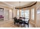 An inviting dining room featuring hardwood floors, a stylish light fixture, and views of the backyard at 17358 Hwy 27, Clermont, FL 34715