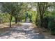 Scenic driveway surrounded by lush trees, creating a private and tranquil entrance to the property at 17358 Hwy 27, Clermont, FL 34715