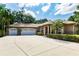 Lovely home with a three-car garage, decorative pillars, and neatly trimmed hedges at 17358 Hwy 27, Clermont, FL 34715