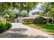 Charming home featuring a long driveway, three-car garage, and well-maintained landscaping at 17358 Hwy 27, Clermont, FL 34715