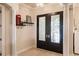 Foyer features stylish double doors, high ceilings, and decorative pillars, complemented by modern accents at 17358 Hwy 27, Clermont, FL 34715
